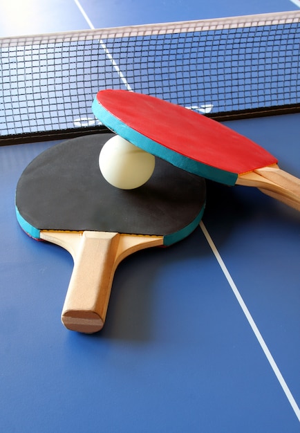 Premium Photo | Rackets and ping pong table