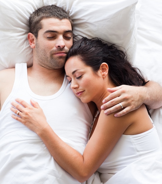 Premium Photo Radiant Couple Lying On A Bed