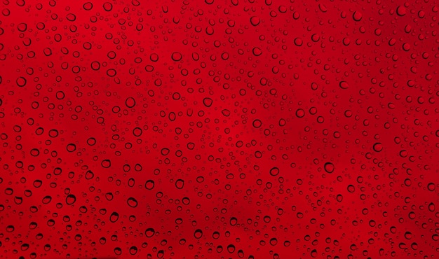 Premium Photo | Rain drops on glass window red background