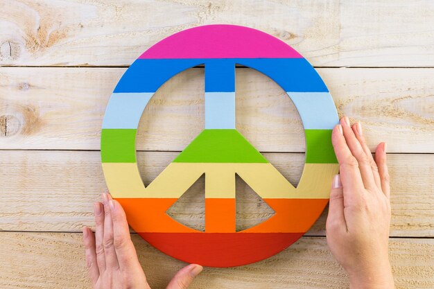 Premium Photo | Rainbow gay pride peace sign on wood background.