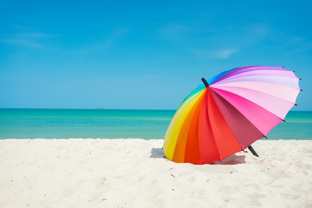 Premium Photo | Rainbow umbrella on beach sand