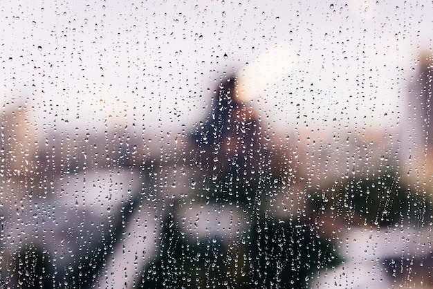 Raindrops On Glass Window With Blur Buildings And Warm Tone Stock