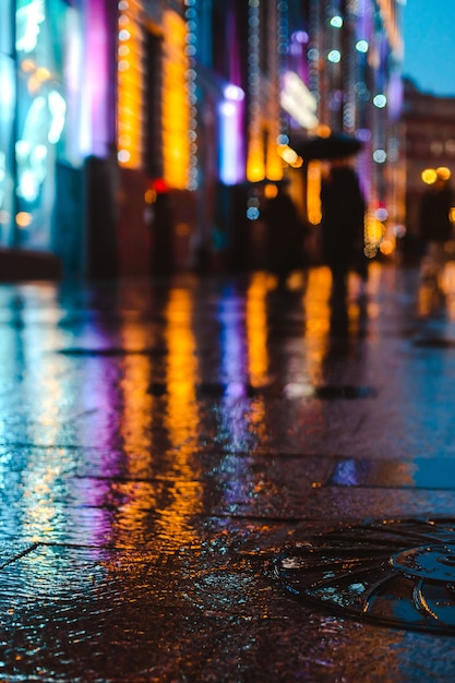 Rainy night in a big city, reflections of lights on the wet road ...