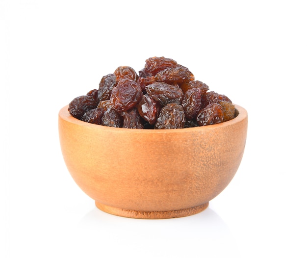 Premium Photo | Raisin on wood bowl isolated on white surface