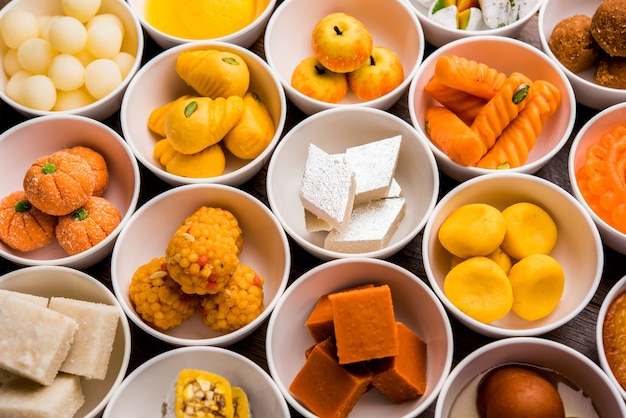 Premium Photo | Rangoli of assorted indian sweets or mithai in bowl for ...