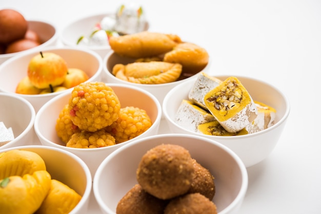 Premium Photo | Rangoli of assorted indian sweets or mithai in bowl for ...