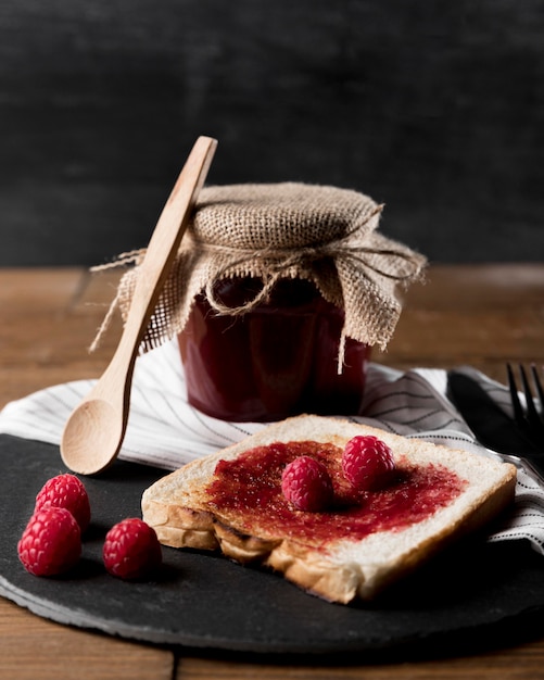 Free Photo Raspberry Jam On Bread With Jar And Spoon