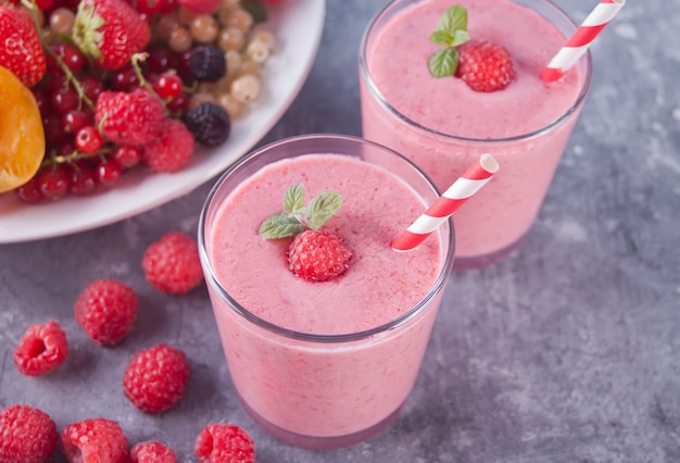 Raspberry smothies and raspberry fruit on the concrete background Premium Photo