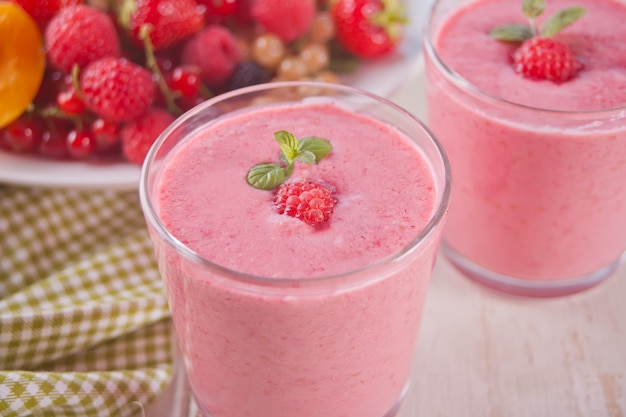 Raspberry smothies and raspberry fruit on the concrete background Premium Photo