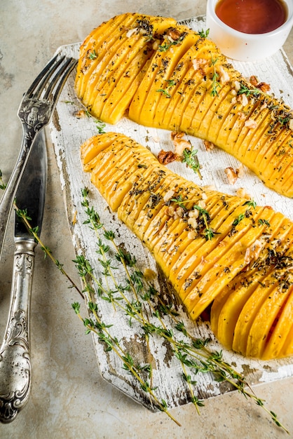 Premium Photo | Rasted baked hasselback pumpkin