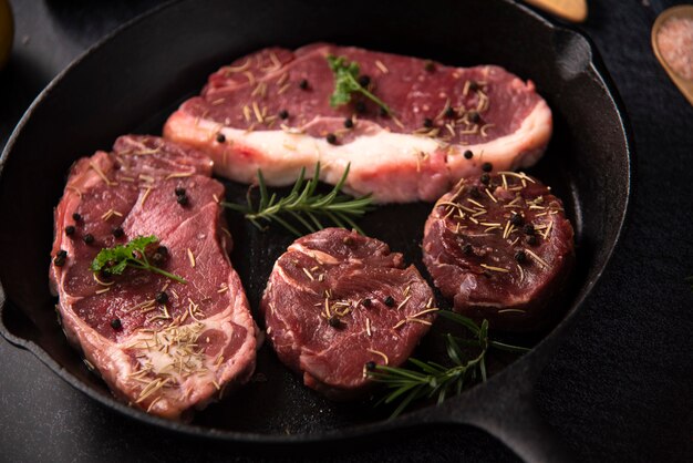 Premium Photo Raw Beef Fillet Steaks With Spices On Wooden Background