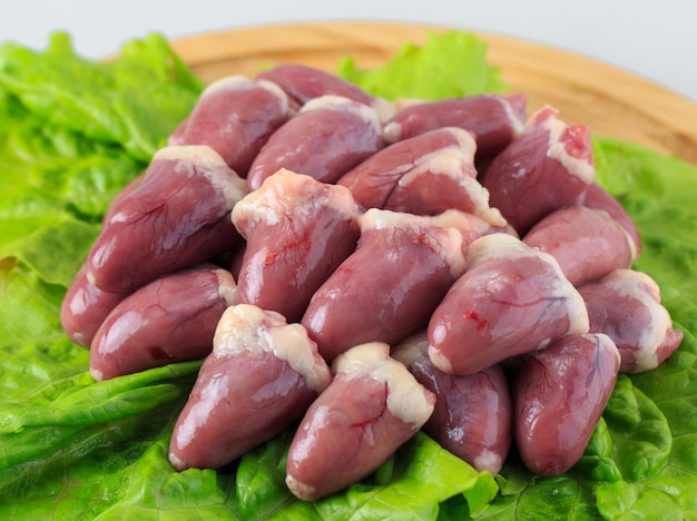 Premium Photo | Raw chicken hearts on white