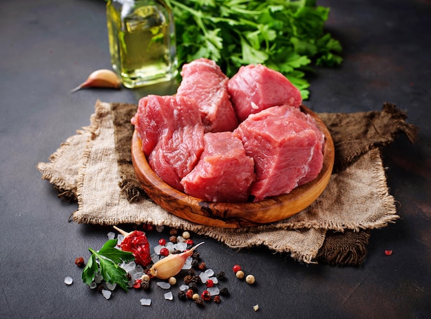 Premium Photo | Raw chopped meat with spices on rusty background