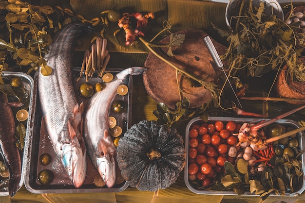 Premium Photo | Raw fish whole with ingredients for cookings