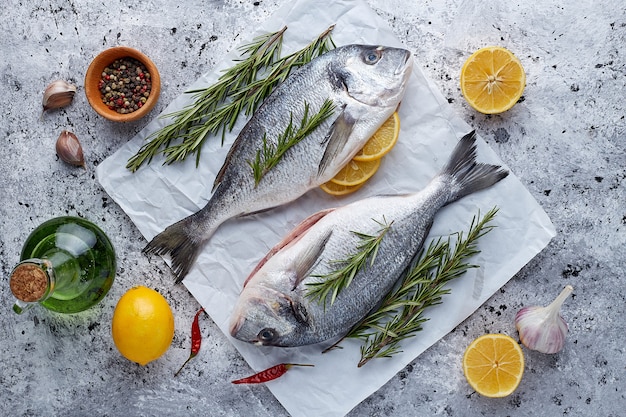 Premium Photo | Raw fresh organic dorado or sea bream on stone or ...