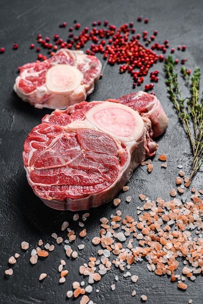 Premium Photo | Raw fresh ossobuco con with herbs. osso buco meat