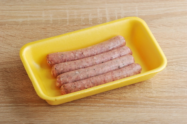 Download Raw Meat Sausages In A Yellow Plastic Tray Premium Photo PSD Mockup Templates