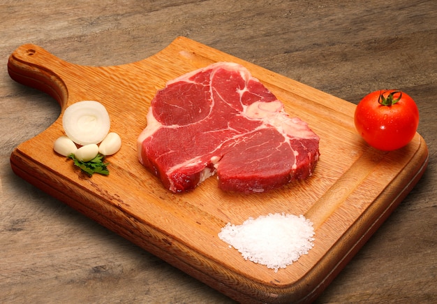 premium-photo-raw-meat-selection-on-wooden-cutting-board