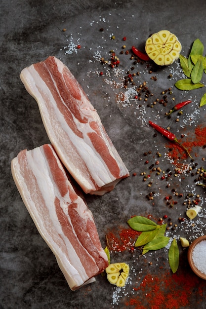 Premium Photo Raw Pork Belly With Skin And Spices And Herbs On Dark Surface