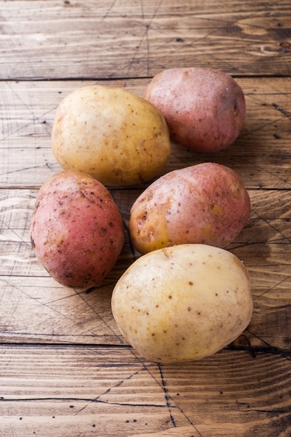 Premium Photo | Raw potato red and yellow food. fresh potatoes on ...