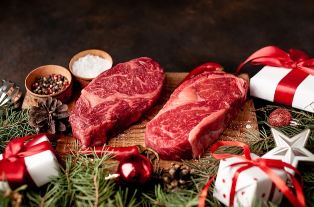 Premium Photo | Raw ribeye beef steaks to cook dinner for christmas