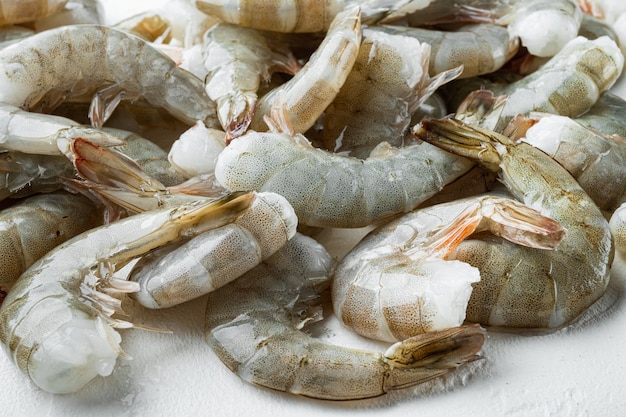 Premium Photo | Raw shell on king prawns set, on white stone