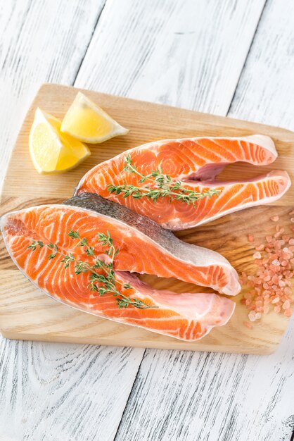 Premium Photo | Raw trout steaks on the wooden board