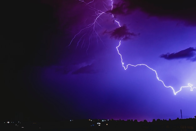 Premium Photo | Rays in a night storm with light and clouds.