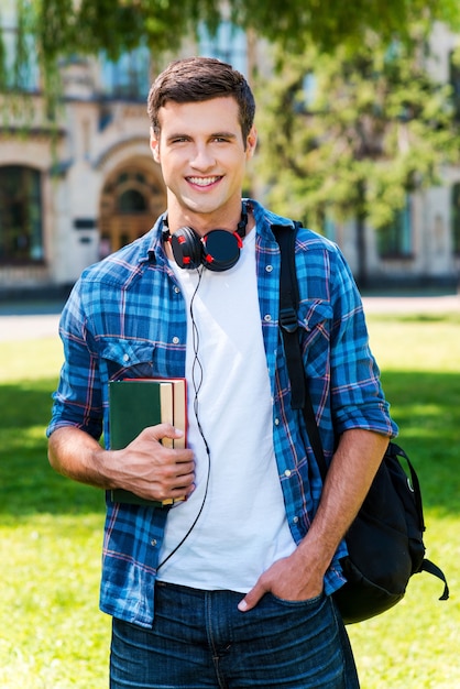 Premium Photo | Ready to study. handsome young man holding books and ...