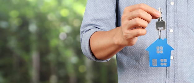 Premium Photo | Real estate agent handing over house keys in hand