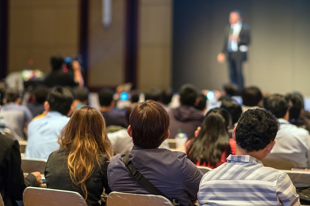 Premium Photo | Rear side of audiences sitting and listening the speackers