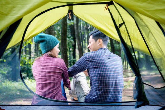 Rear view of asian couple relaxing outside the tent Premium Photo