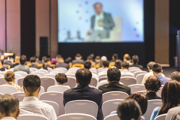 Rear View Of Audience Listening Speakers On The Stage In The Conference Hall Or Seminar Meeting Premium Photo