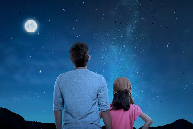 Rear View Of Father And Little Daughter Looking At Night -5808