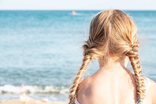 Premium Photo Rear View Of A Girl With Pigtails On The Beach In Summer