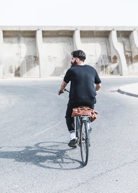 道路で自転車に乗る人の後姿 無料の写真