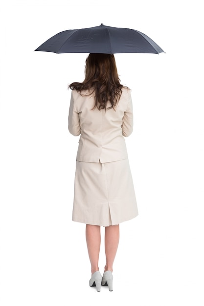 傘を持つ上品な実業家の後姿 プレミアム写真