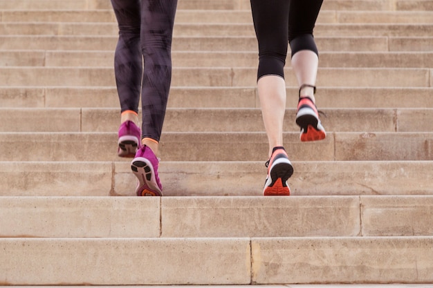 Rear view of healthy women climbing stairs Free Photo