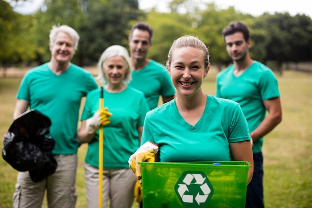 Premium Photo | Recycling team members standing in park