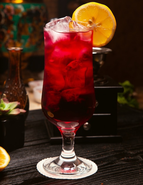 Free Photo | Red alcohol cocktail in glass with ice cubes and lemon slice