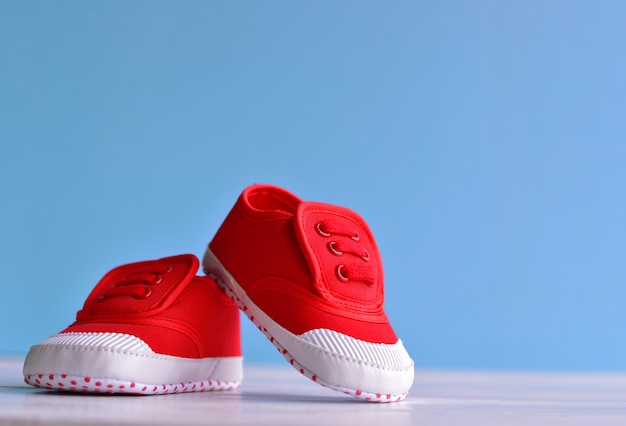 Premium Photo | Red baby boy shoes on 