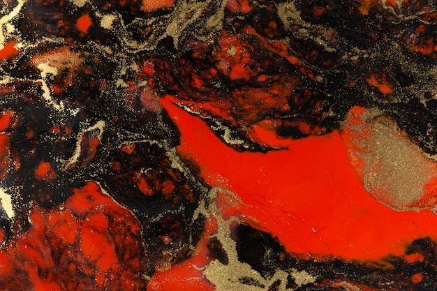 赤、黒、ゴールドの液体の背景をペイントします。抽象的な大理石の 