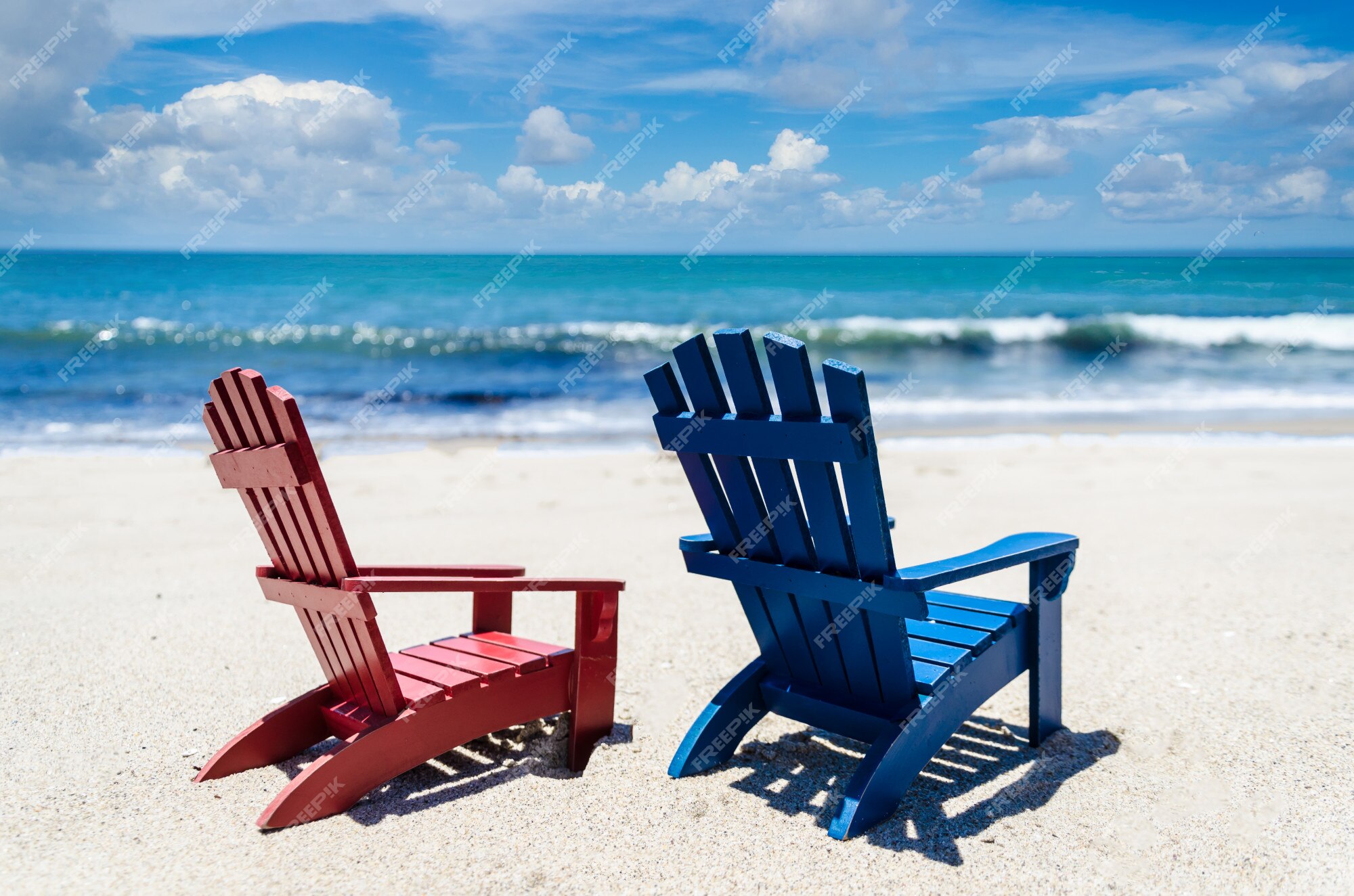 Premium Photo | Red and blue beach chairs near ocean