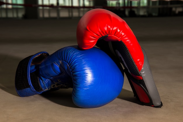 Premium Photo | Red and blue boxing glove on boxing ring in gym