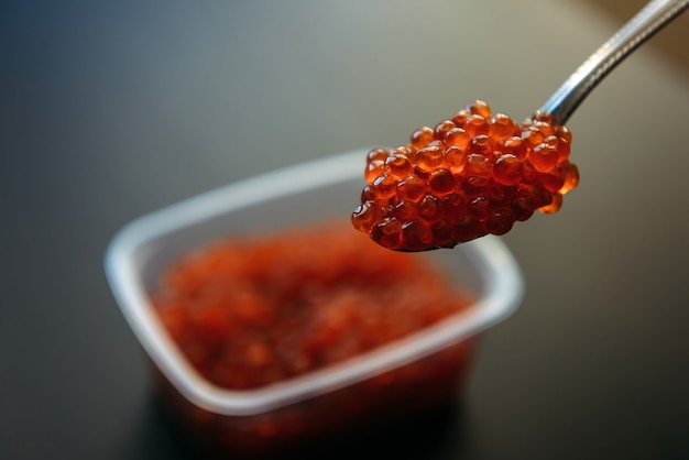 Download Premium Photo Red Caviar In A Spoon And In Plastic Container Close Up Salmon Caviar Delicatessen Seafood