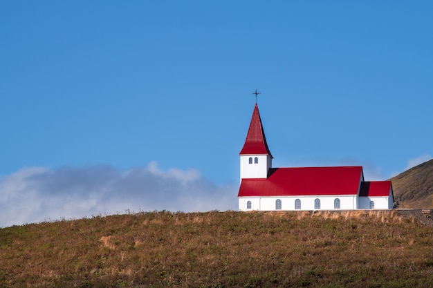 Premium Photo | Red church on the montain with blue sky in iceland