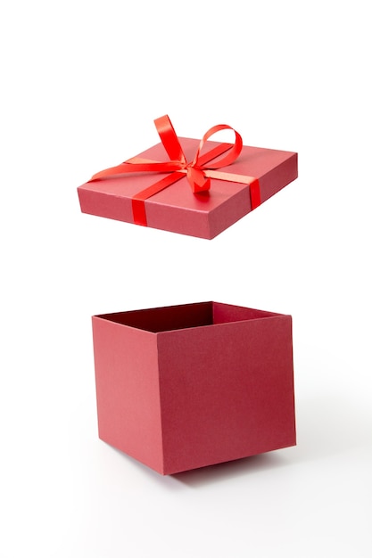 Premium Photo | Red gift box open with ribbon isolated on white background