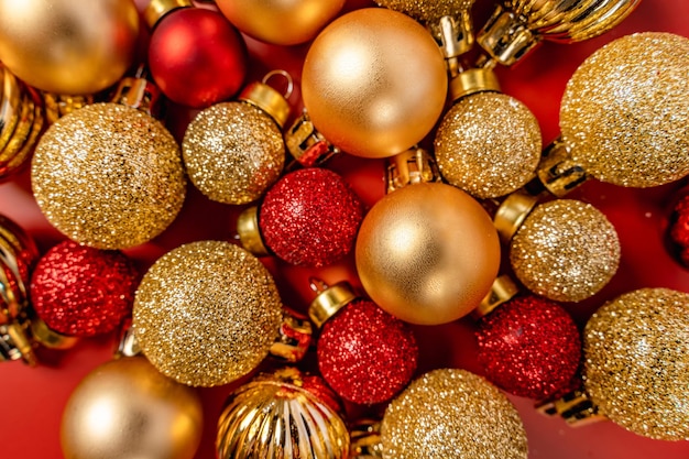 Premium Photo | Red and gold christmas balls lie on a red background a ...