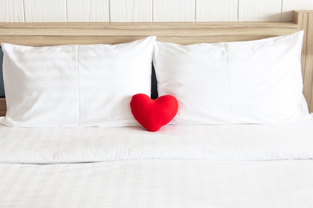 Red heart and couple white pillow on the bed for love, wedding and ...