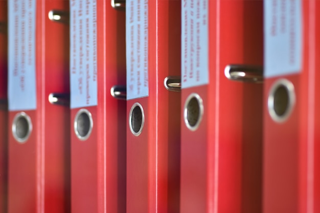 Red large folders files with inscriptions for storing office documents Premium Photo